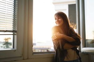 a woman is happy and healthy after deciding to get sober in the new year